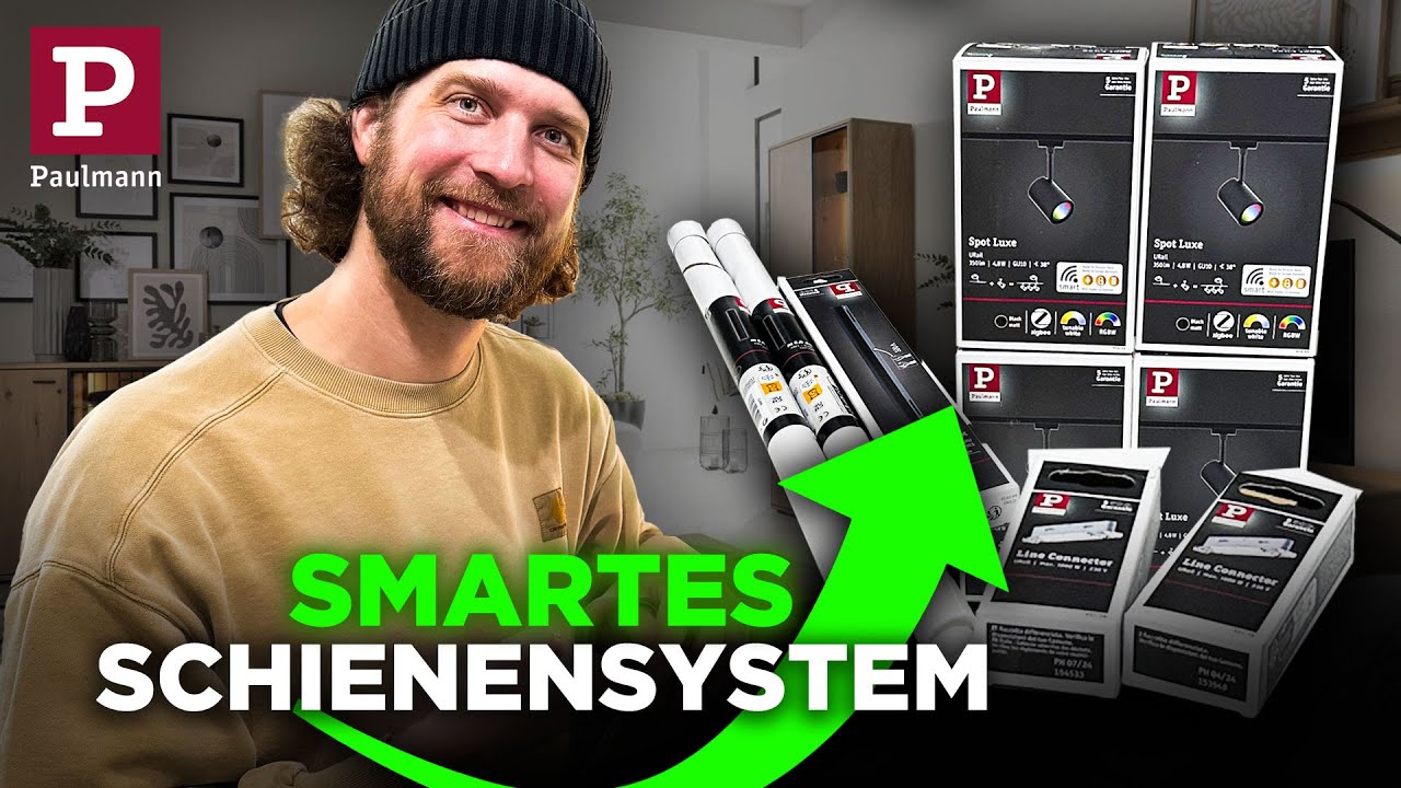 Vorschaubild: Tobias Haack mit Mütze, daneben verpackte Schienen und Kartons mit Spots und Verbindern von Paulmann, oben links das Paulmann-Logo, Schriftzug „Smartes Schienensystem“